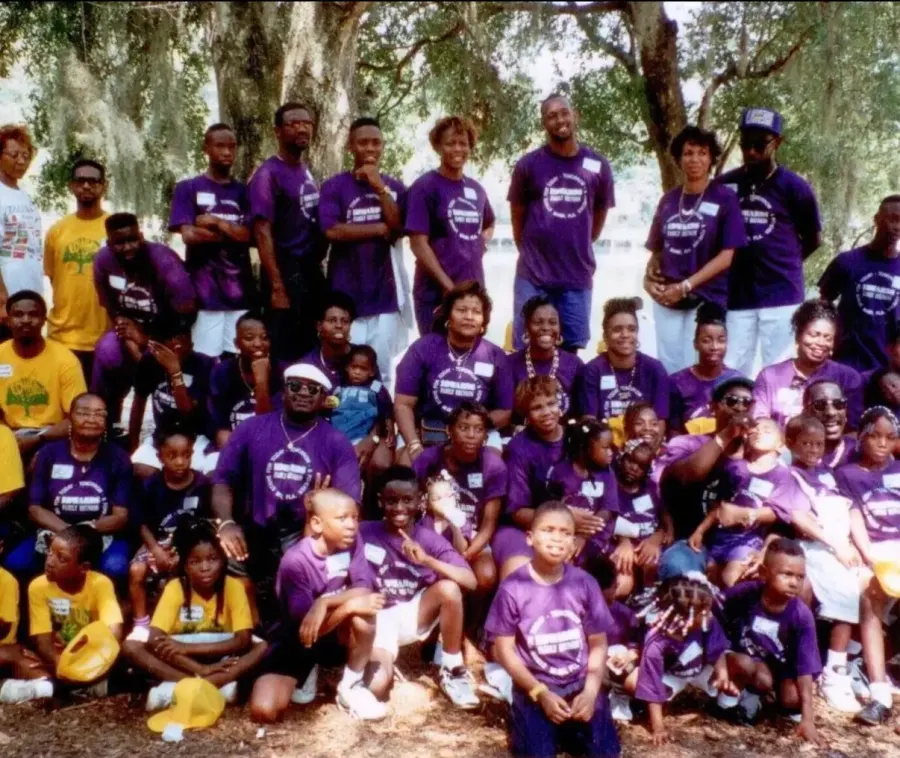 A past Edwards family reunion: rows of relatives in purple reunion T-shirts beneath moss-hung oaks.