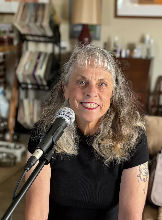 Susan of Rustic Roads, singing at a microphone
