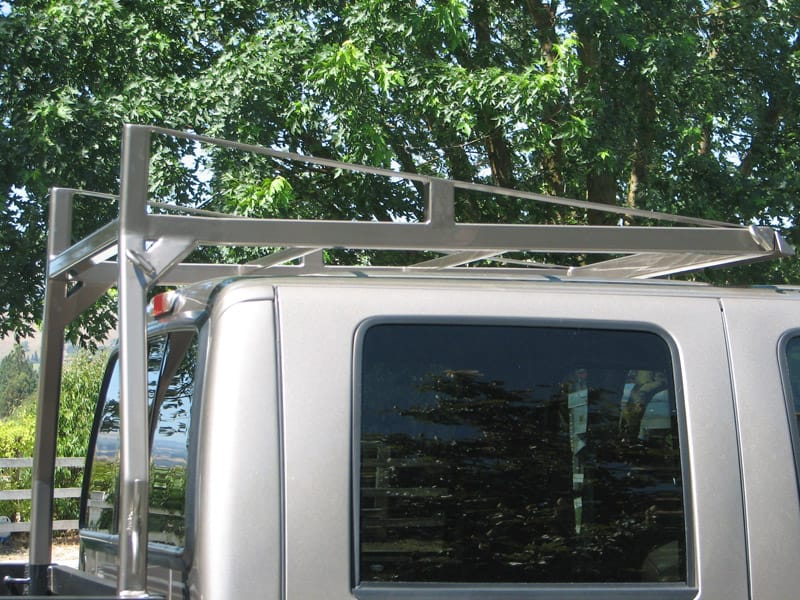 White truck with over-cab steel rack extension