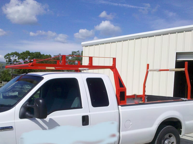 Custom red powder-coated over-cab truck rack fabricated by David's Custom Metalworks