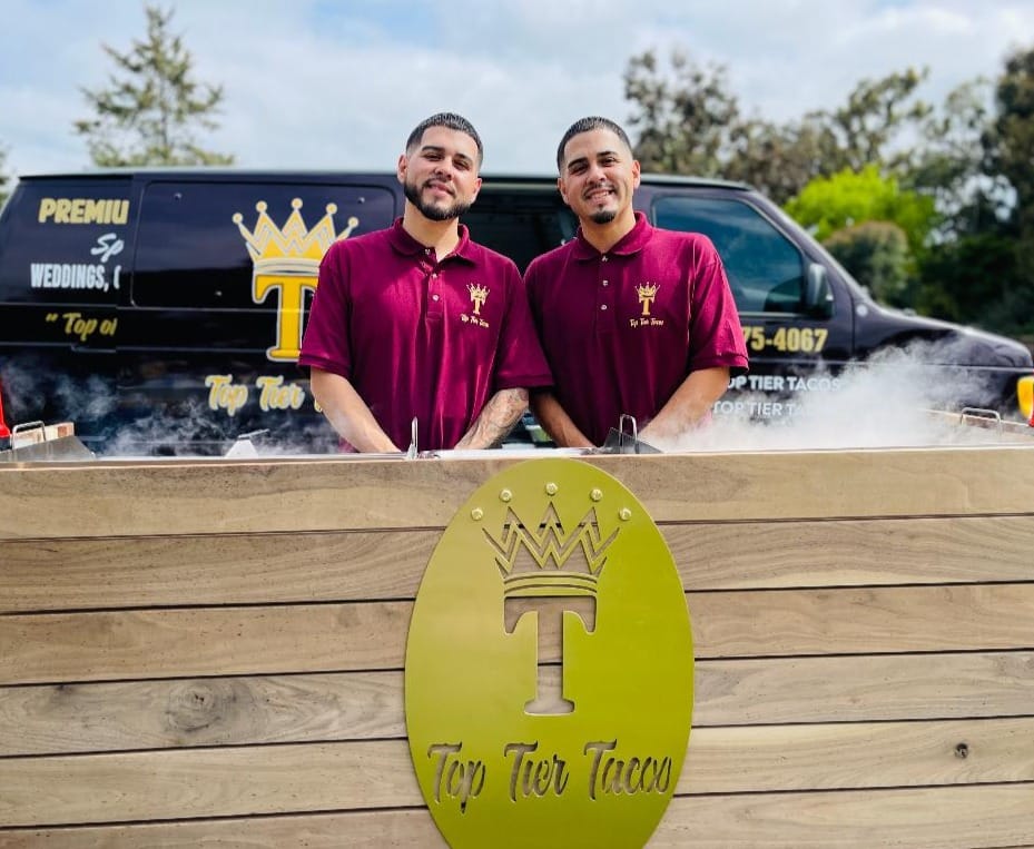 Ray and Ricki, the twin brothers and owners of Top Tier Tacos, standing in front of their branded truck
