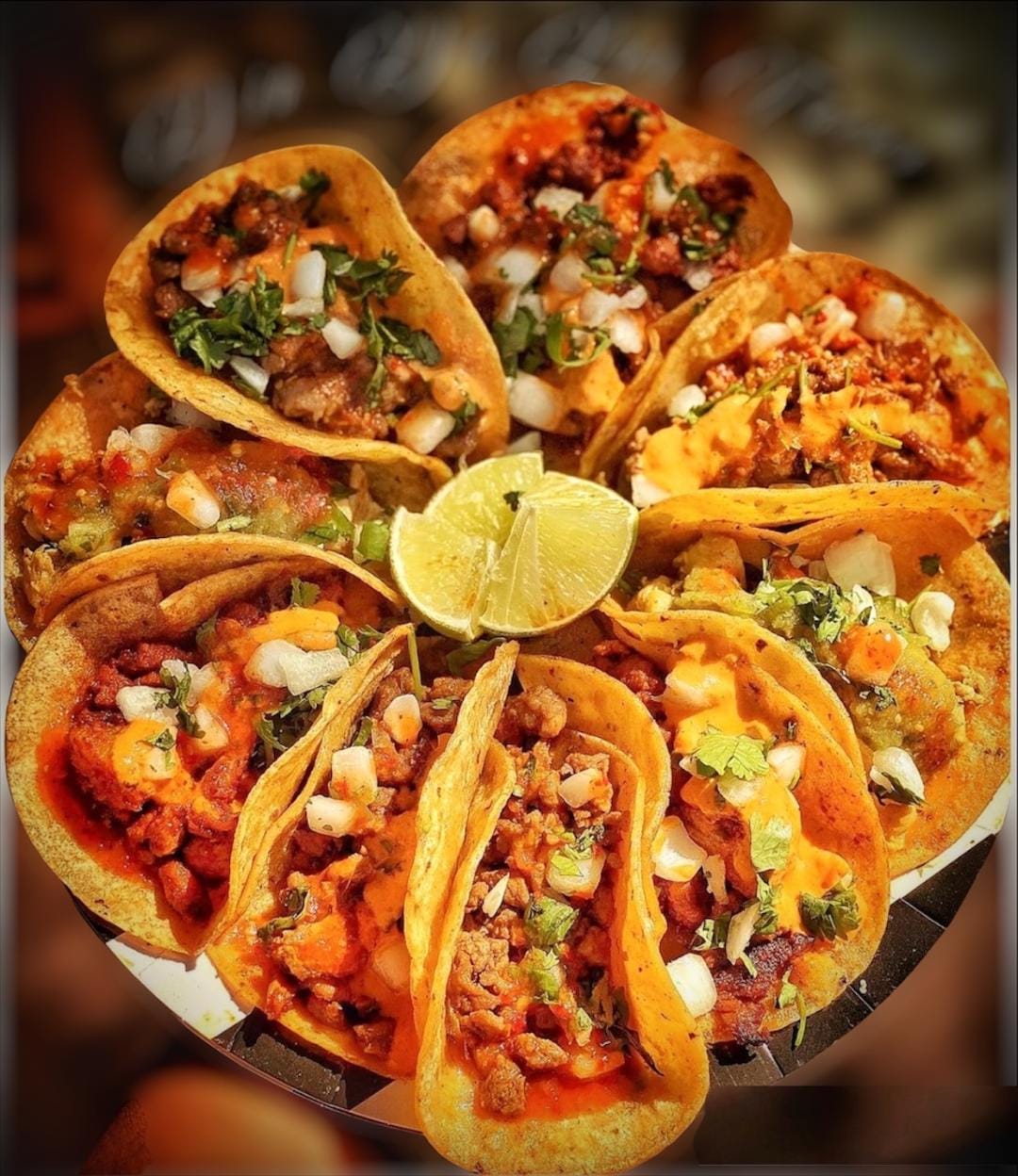 Close-up of street tacos with lime, cilantro, and onions